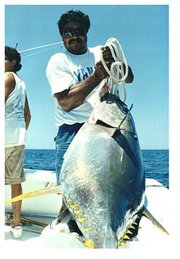 a guy with the huge fish he's caught